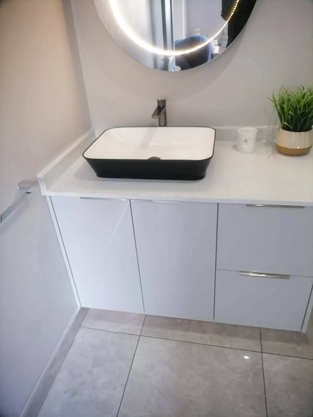 Bathroom vanity with vessel basin installed during a renovation