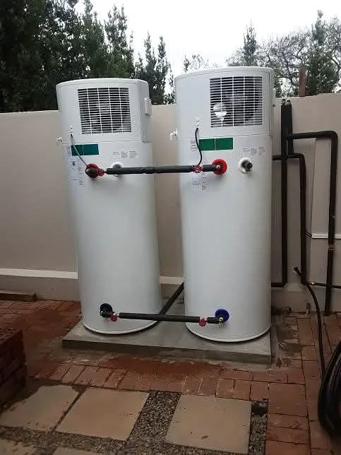 Two geysers installed side by side on an outside wall