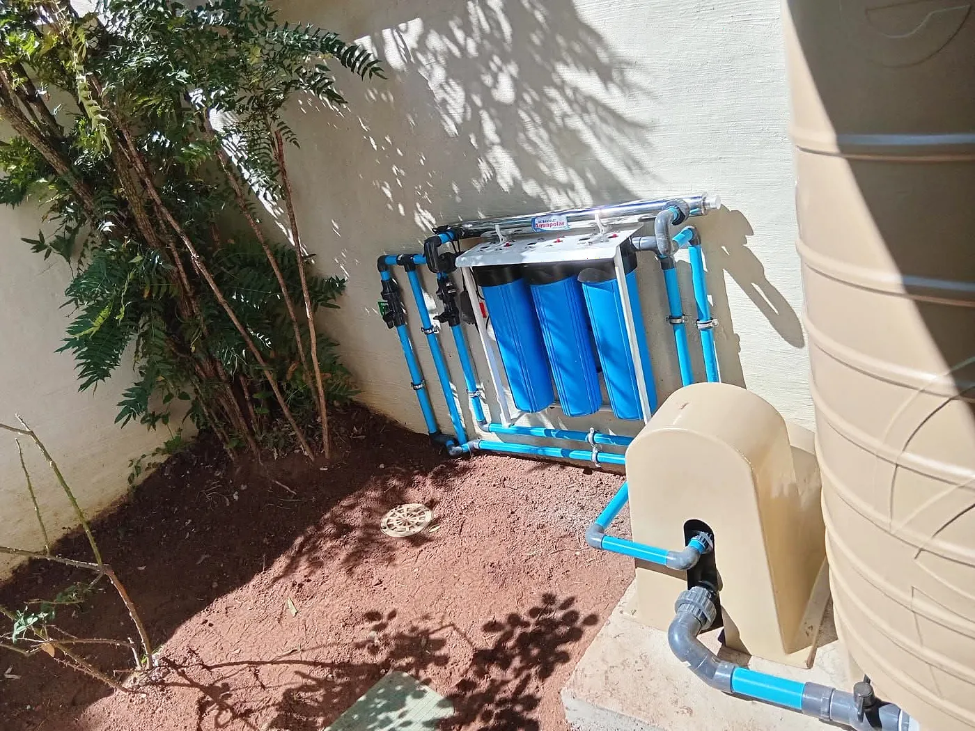 Water tank with pump and filters installed in a garden