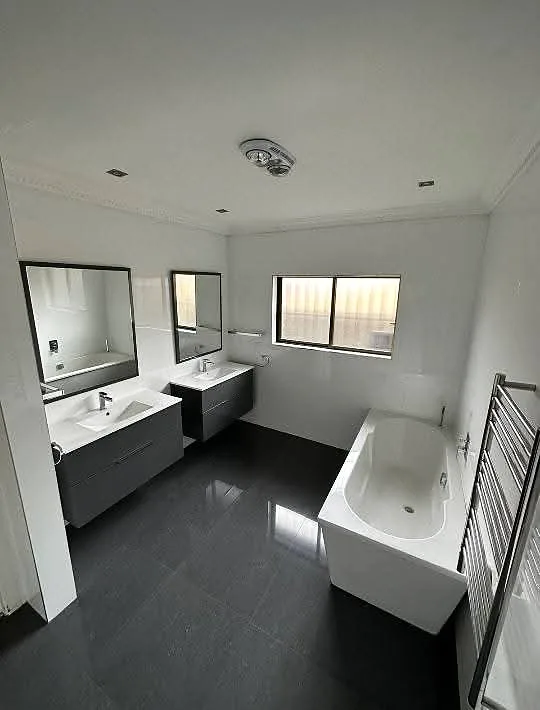 Renovated bathroom with freestanding bath and double vanity
