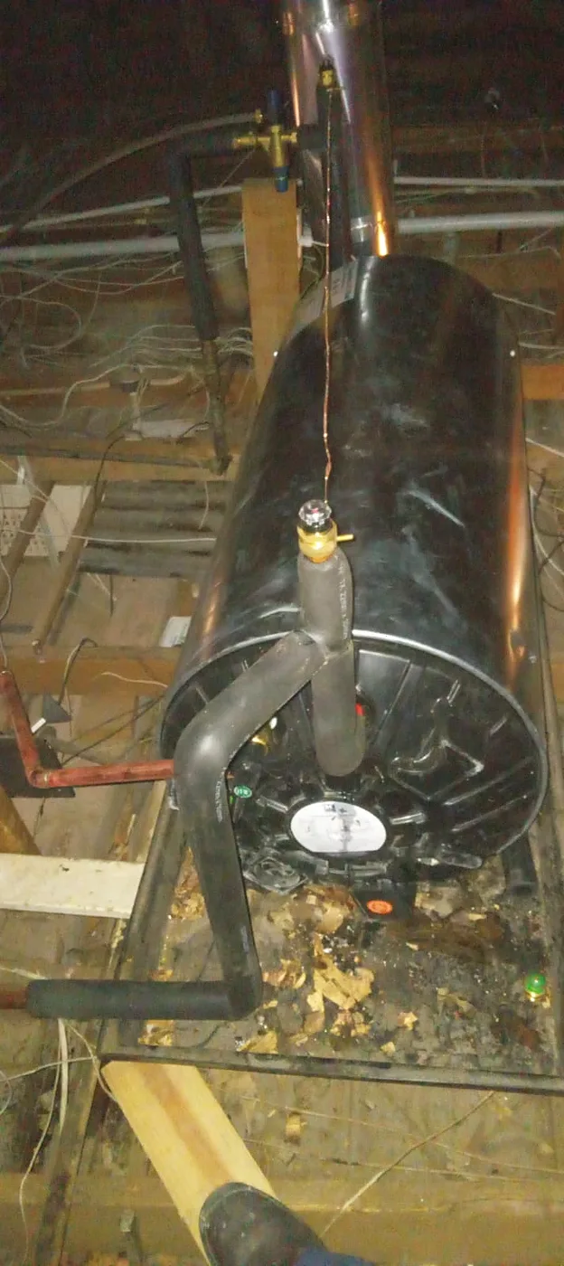 Geyser installed in a roof space with connected pipework