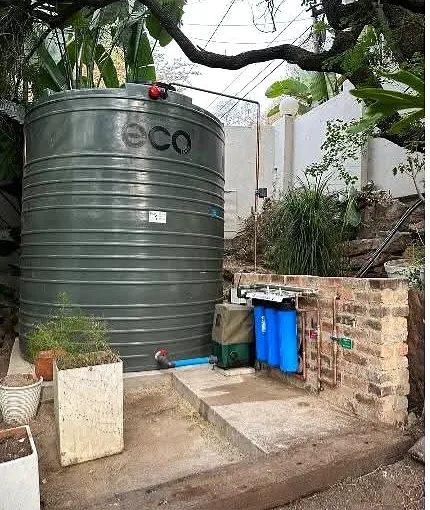 Water storage tank with pump and filtration installed at a property